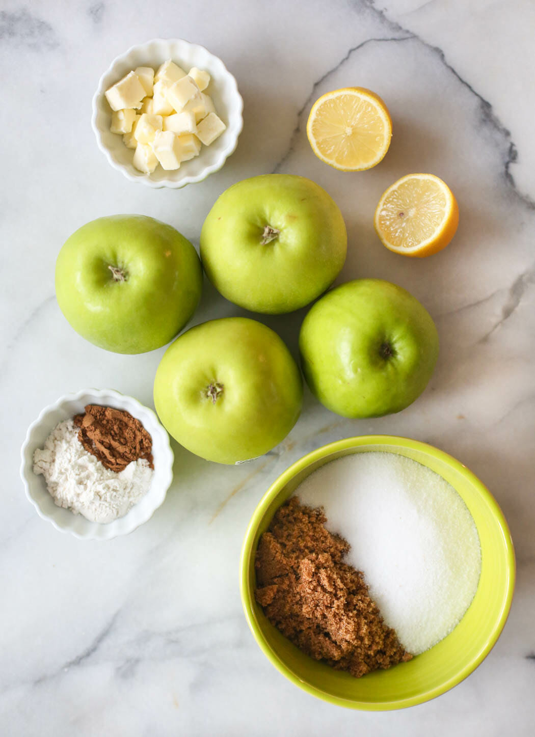 Ingredients for apple pie on a marble slab