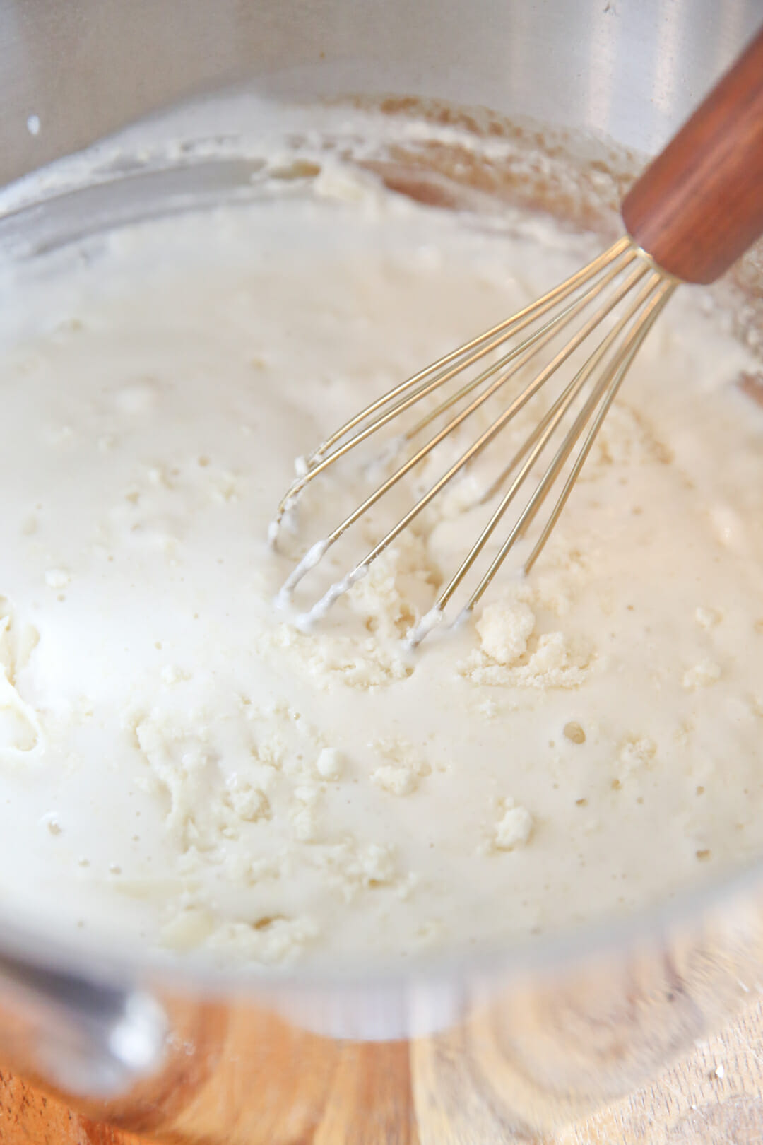 Whisking parmesan into alfredo