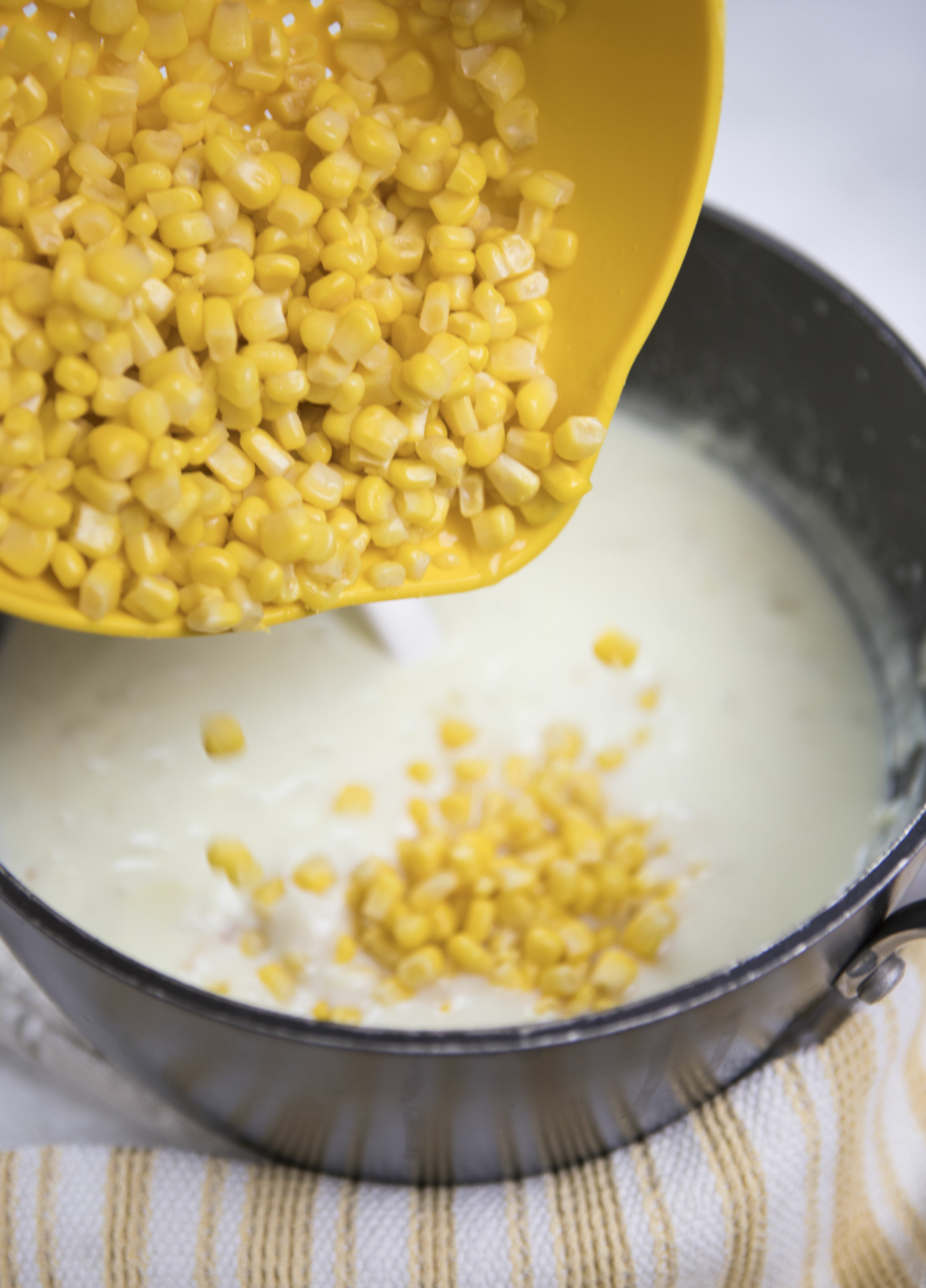Adding corn to creamy corn chowder