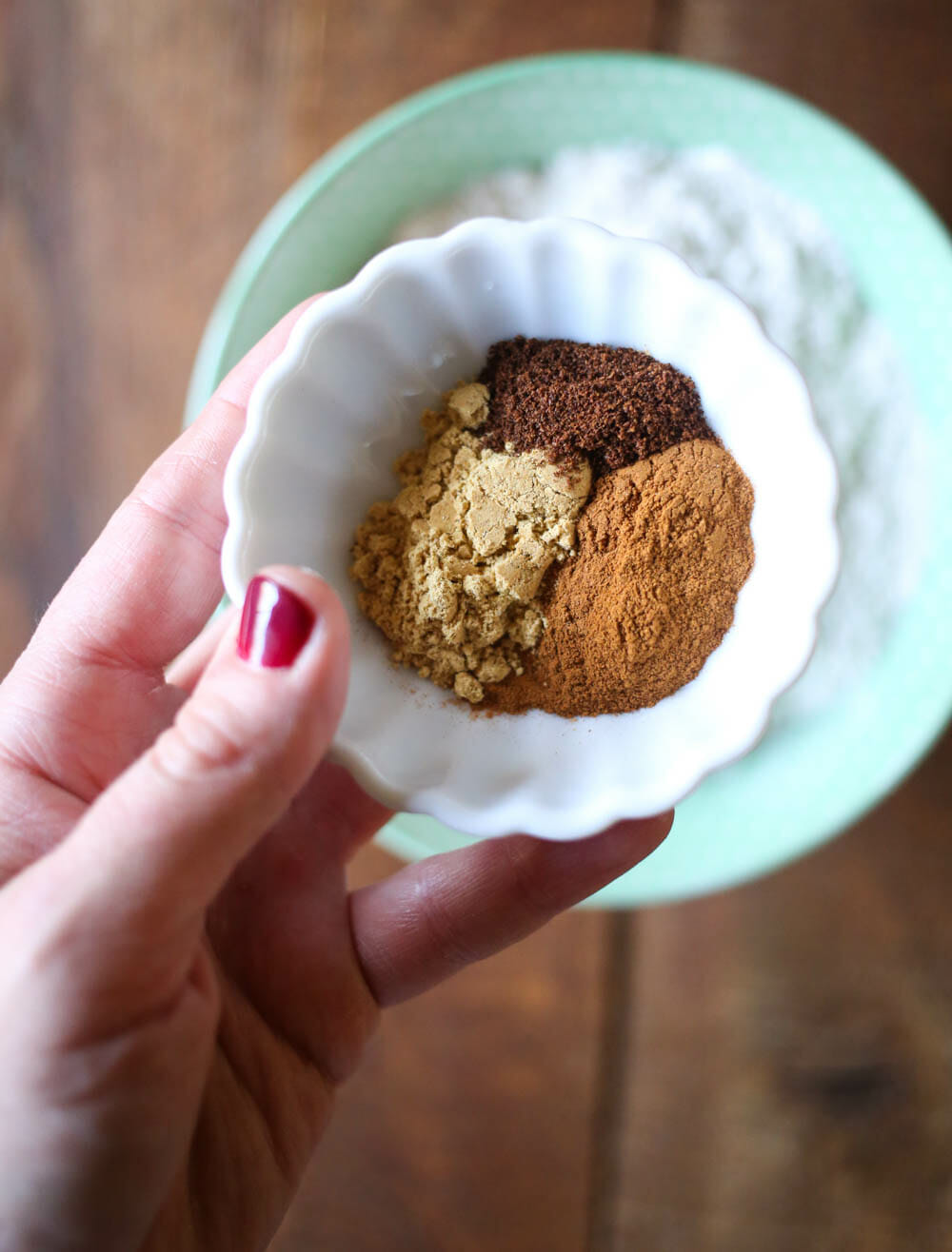 adding spices to ginger spice cookies