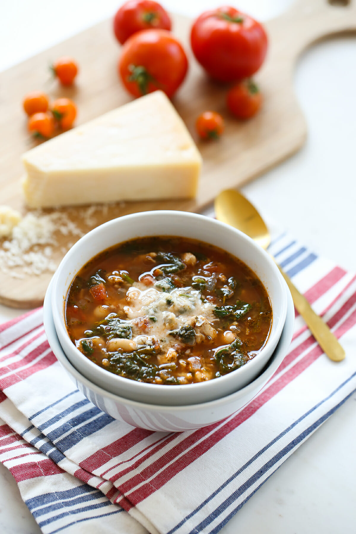 tomato soup in bowl with cheese on the side