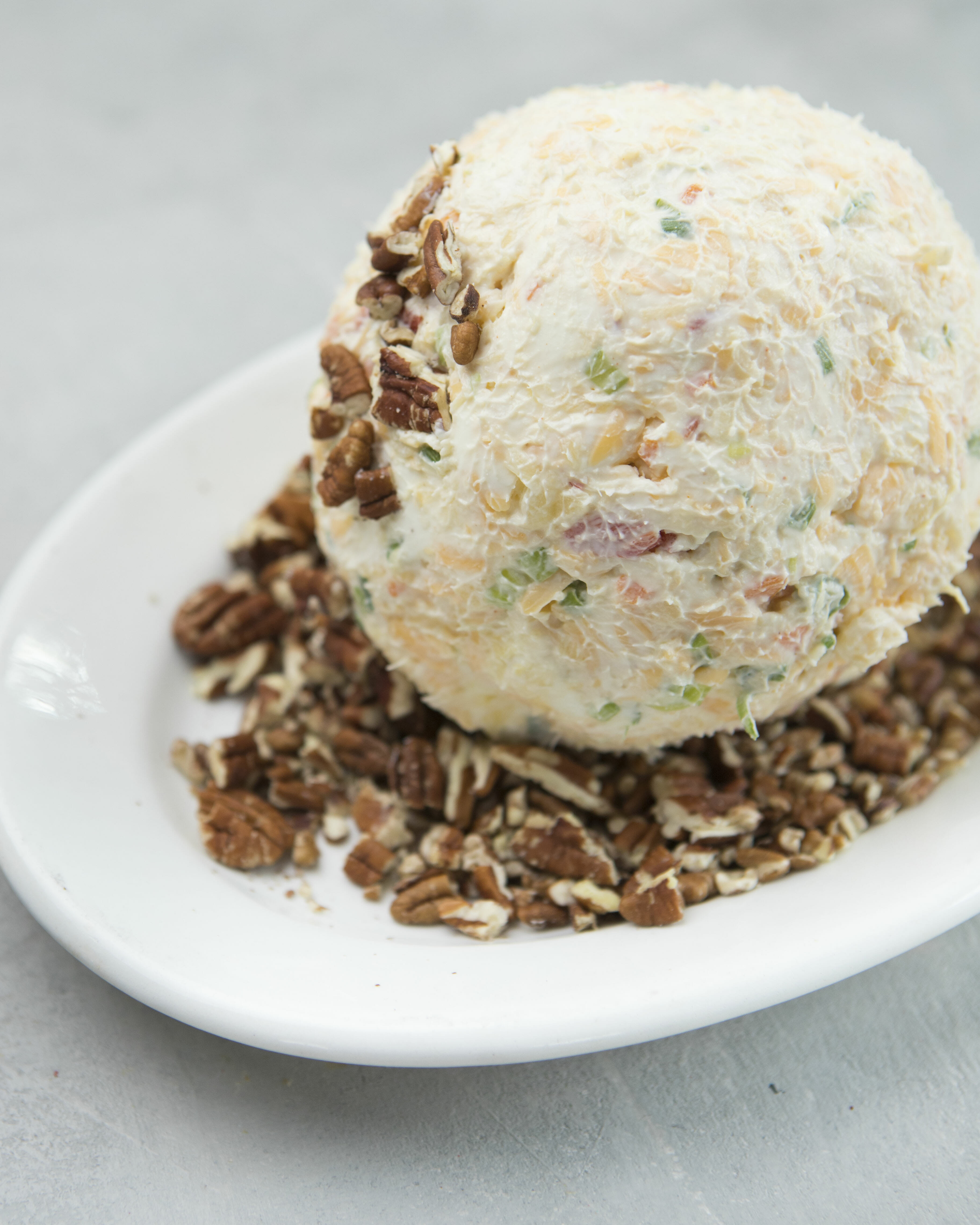 rolling cheeseball in pecans