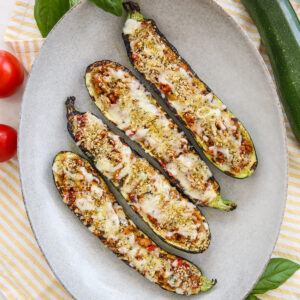 Grilled stuffed zucchini on a platter