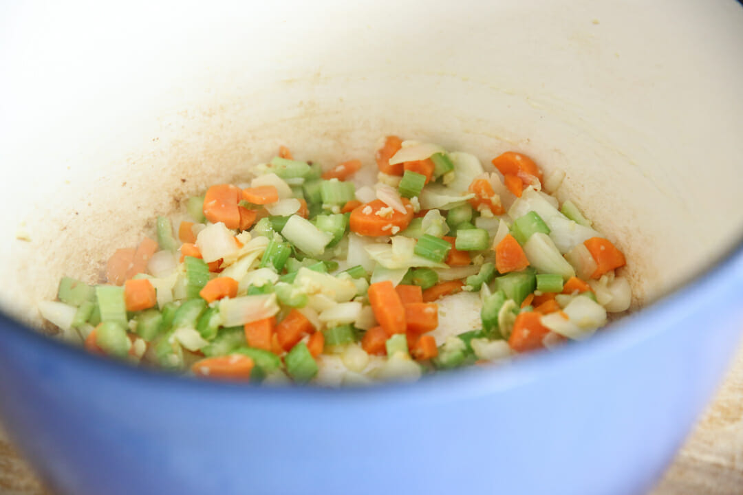 onions, celery and carrots in pan