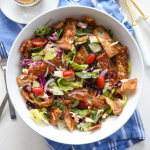 asian wonton salad in a white bowl