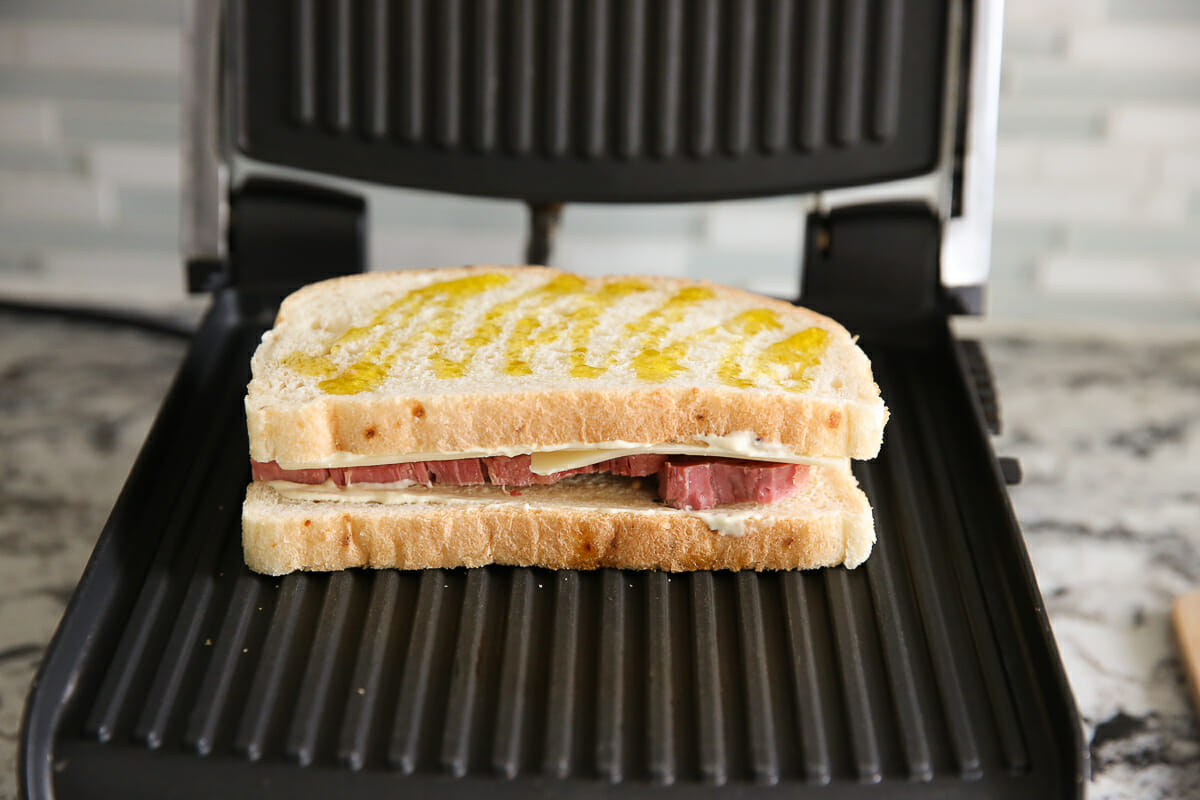 toasting Corned Beef Sandwich on panini press