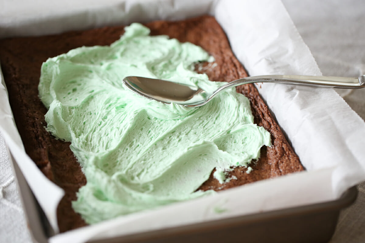 spreading frosting on mint brownies