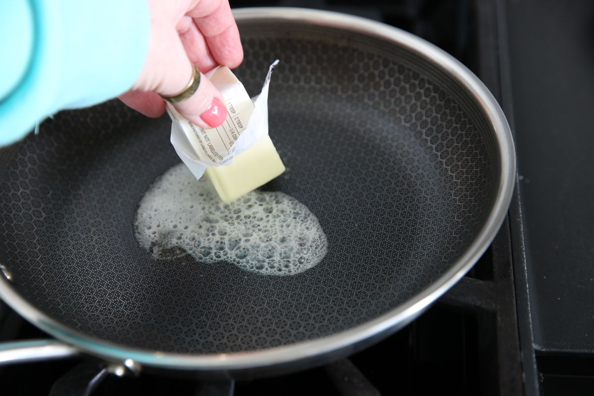 putting butter in a hot skillet