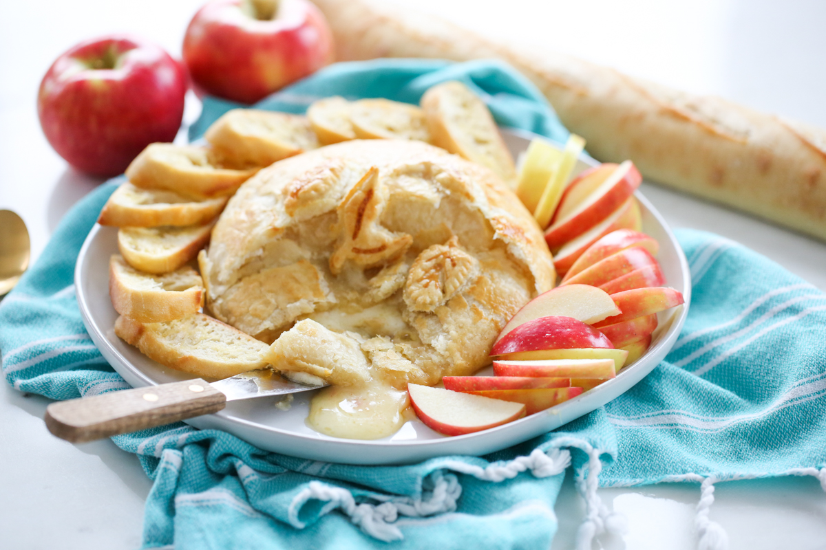 baked brie with pepper jelly on a serving player