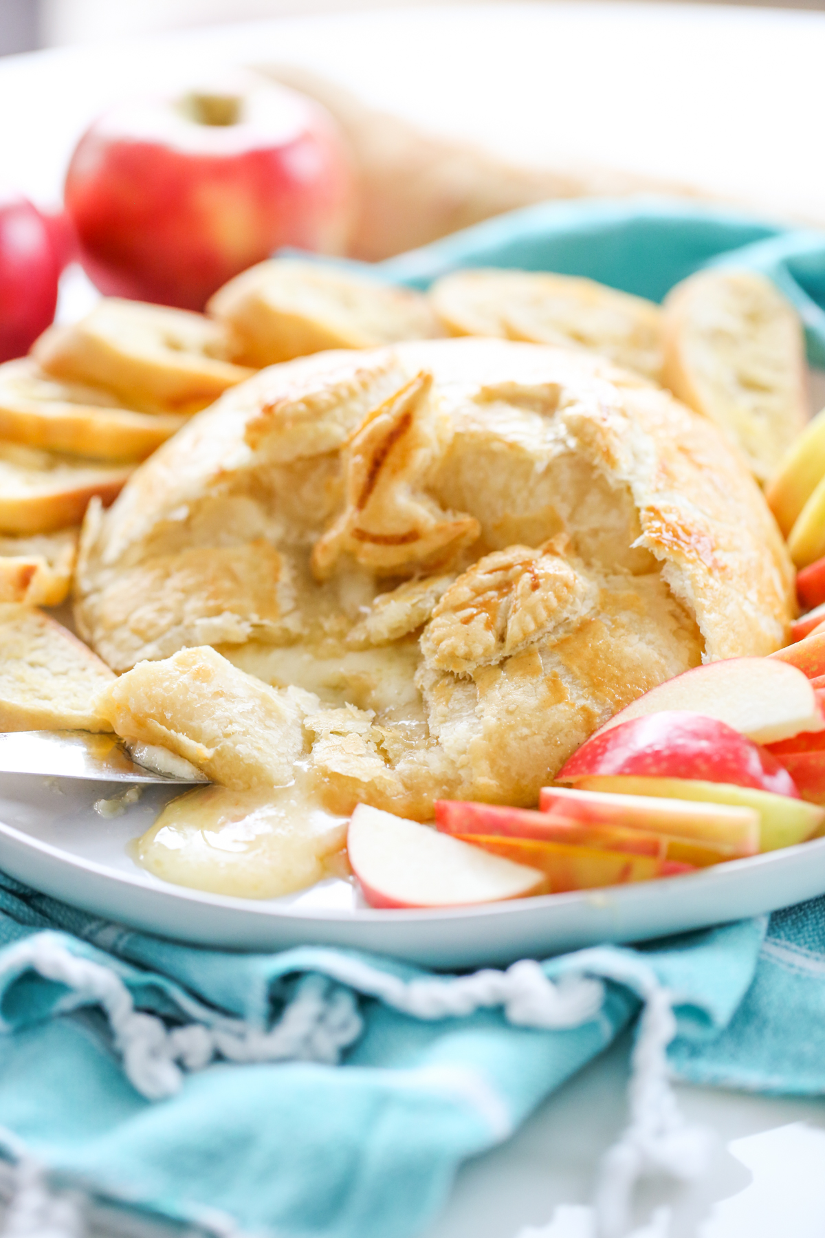 Baked Brie with Pepper Jelly on a platter with apple slices