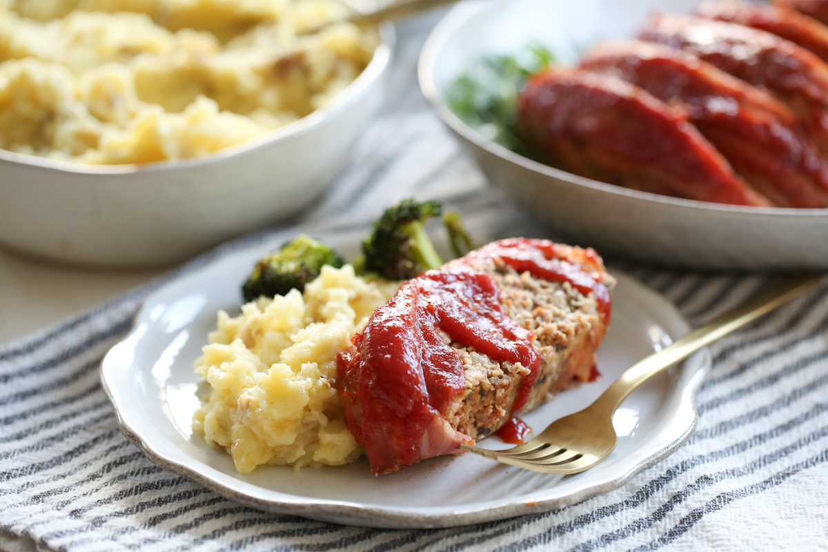 meatloaf on a plate with mashed potatoes and broccoli