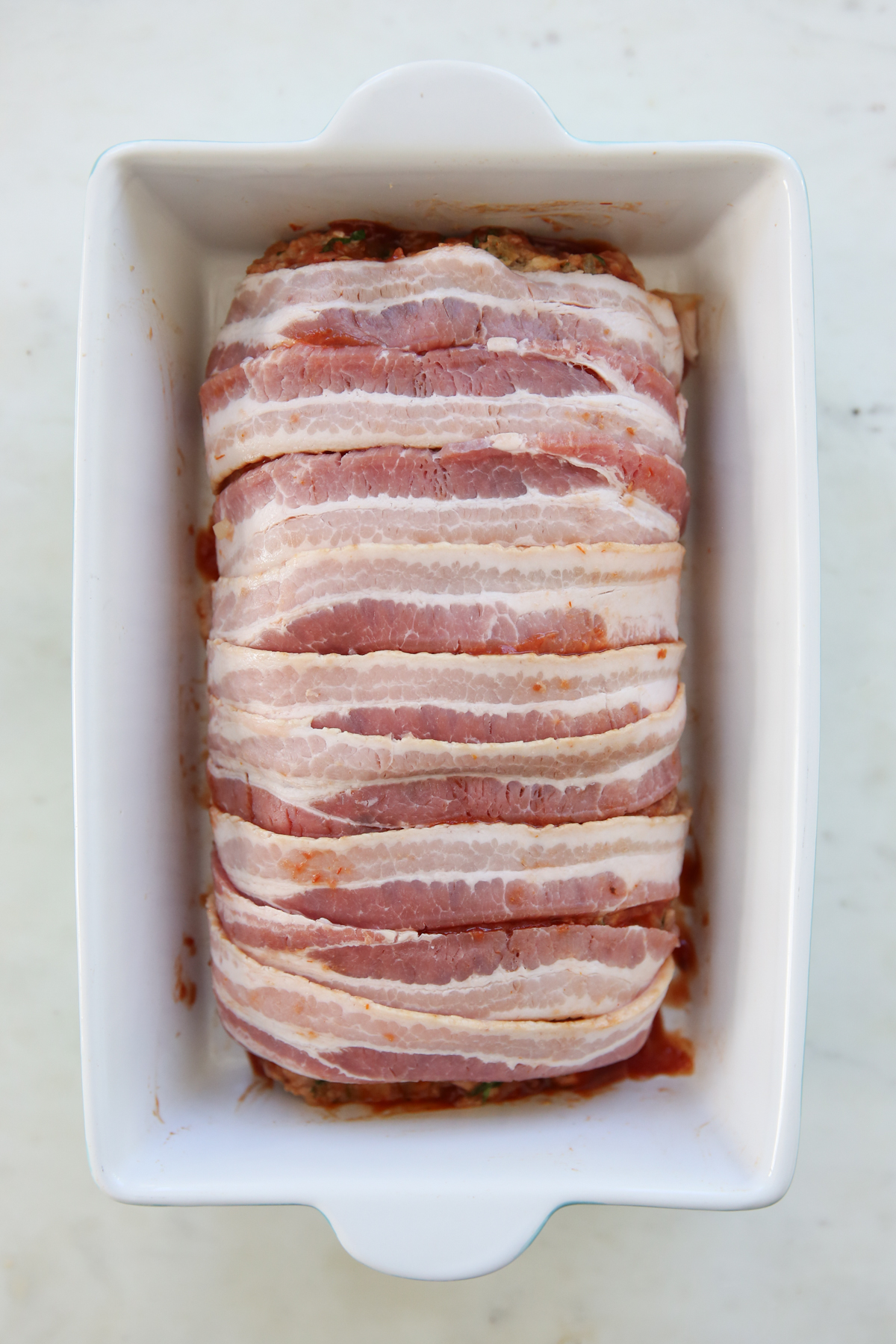 meatloaf wrapped in bacon in a pan