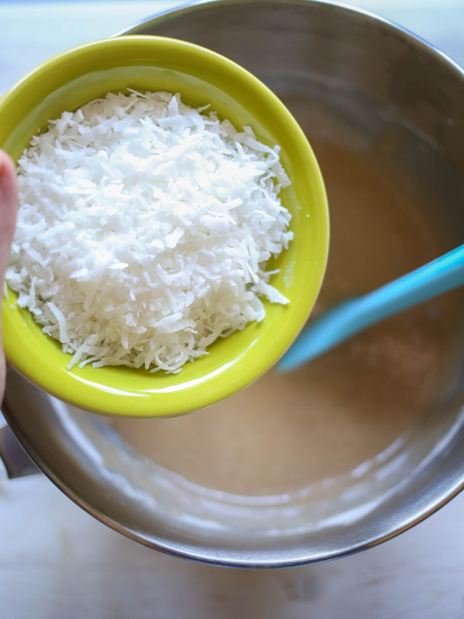adding coconut to carrot cake