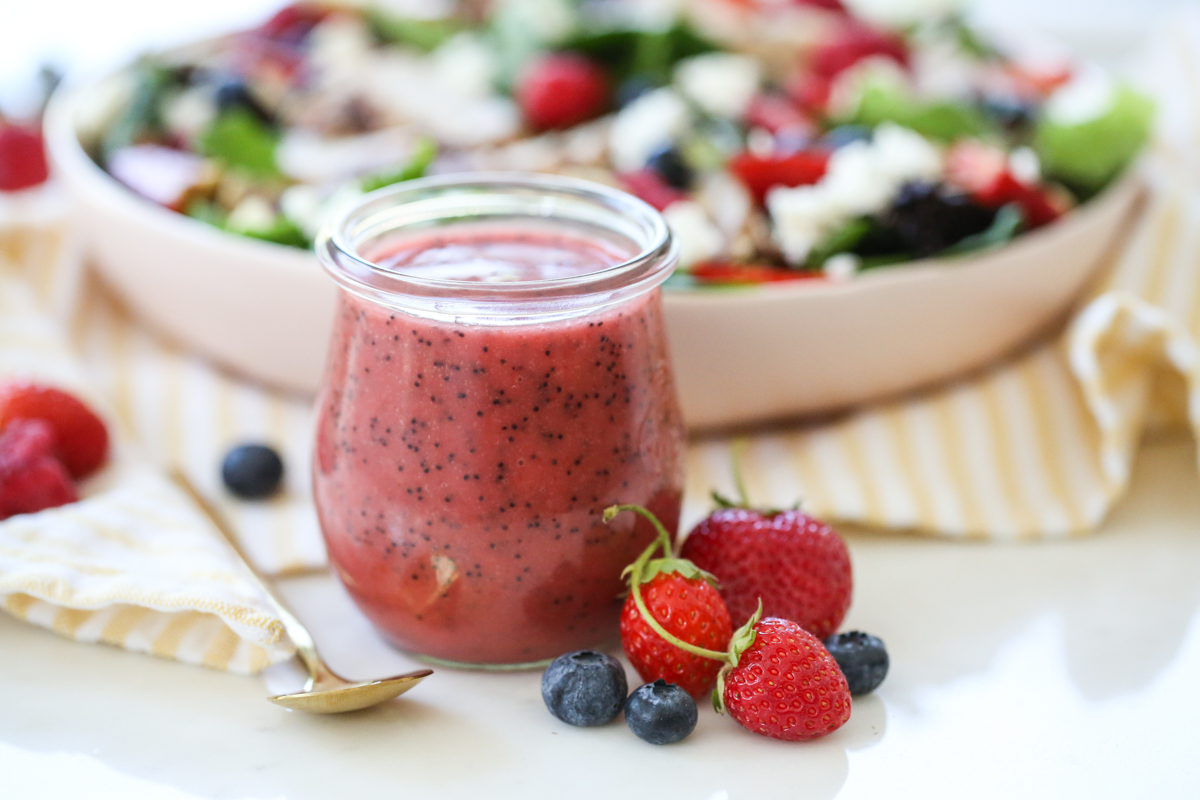 Berry Poppyseed Vinaigrette in jar with a salad