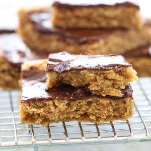 stacked peanut butter cookie bars on cooling rack