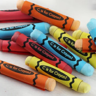 A pile of candy crayons in red, yellow, blue, and orange.