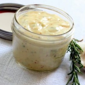 Homemade garlic rosemary mayonnaise in a small mason jar.