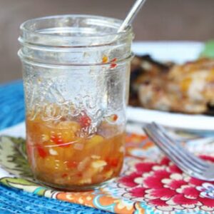 A mason jar of spicy peach bbq sauce