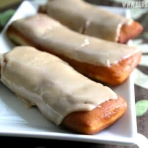 3 homemade maple bars on a white plate.