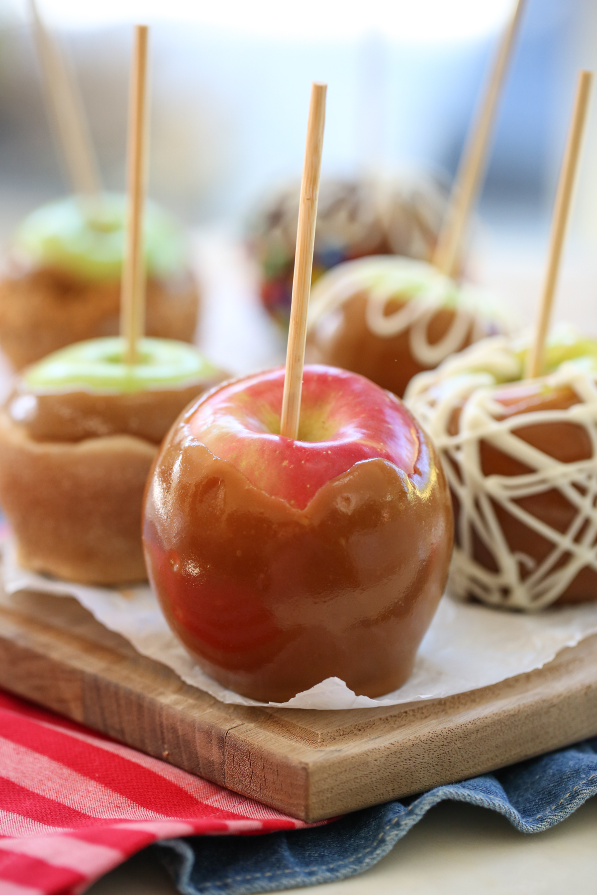 caramel apples in a row with fun toppings