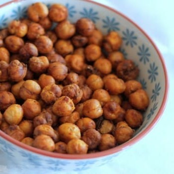 A bowl full of roasted spicy chickpeas.