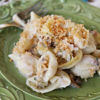 A serving of tuna noodle casserole made with pasta shells and homemade sauce on a green plate.