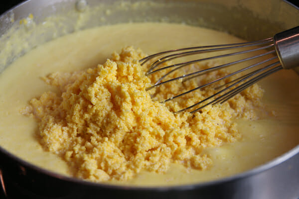 https://ourbestbites.com/wp-content/uploads/2012/11/Adding-corn-meal.jpg