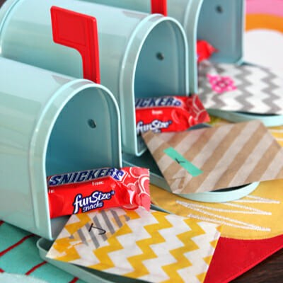 A series of tiny mailboxes, each with a mini Snickers and a little note in an envelope.