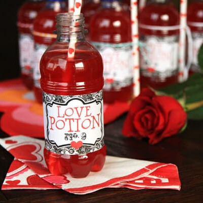 A bottle of "love potion" (store bought red drink with a printable love potion label on it).