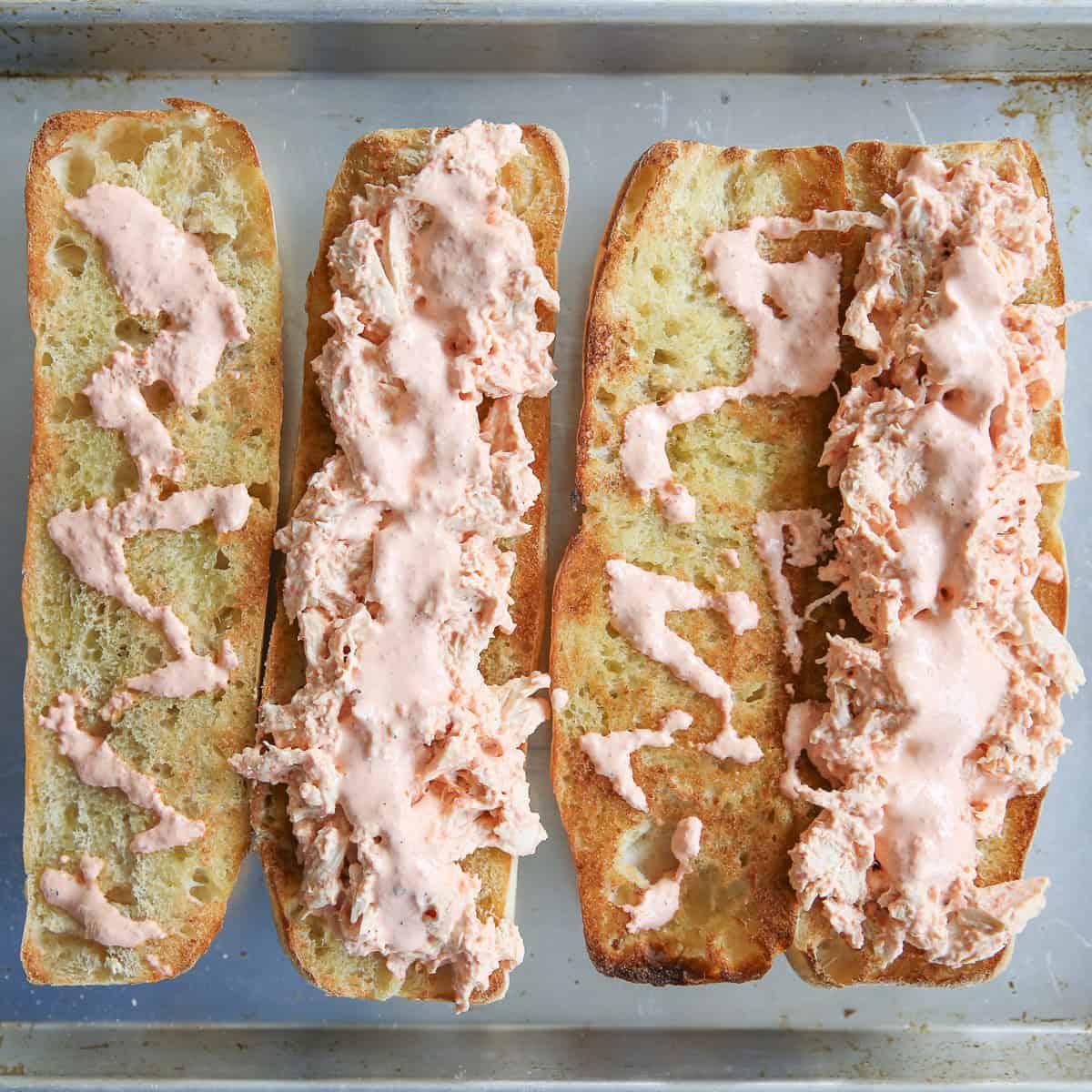 open faced sandwiches on a baking sheet