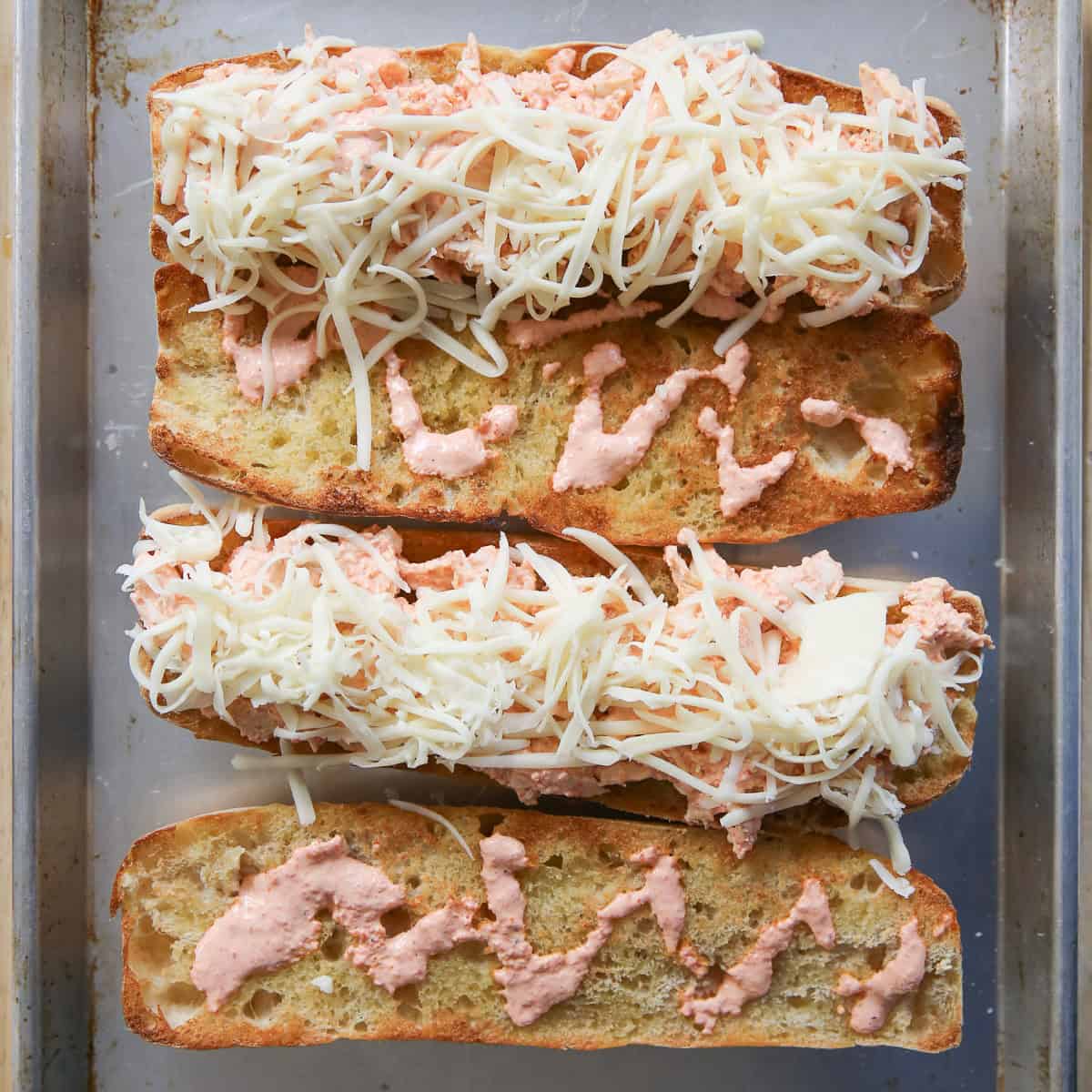 open faced sandwiches on a baking sheet