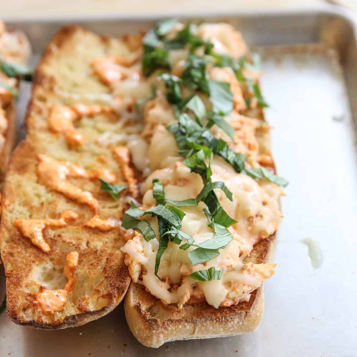 open faced sandwiches on a baking sheet