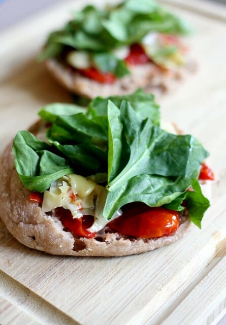 spinach and basil on english muffin pizzas