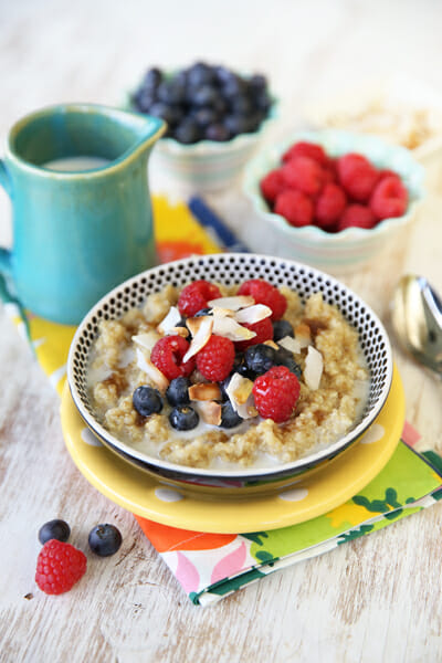 Delicious and wholesome Coconut and Berry Topped Sweet Breakfast Quinoa from Our Best Bites