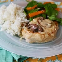 Baked pork chops in creamy Brie and mushroom sauce from Our Best Bites