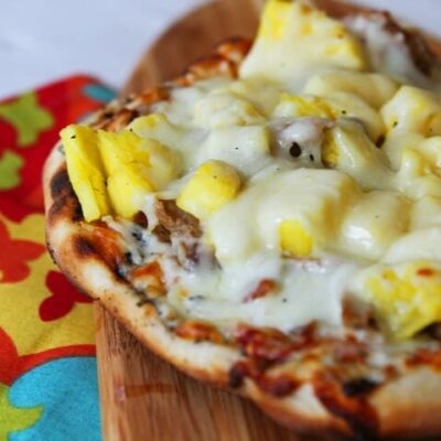 A crispy crust topped with Hawaiian pork, pineapple, and cheese.