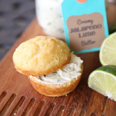 A cornbread muffin, cut in half and spread with creamy jalapeno lime butter.