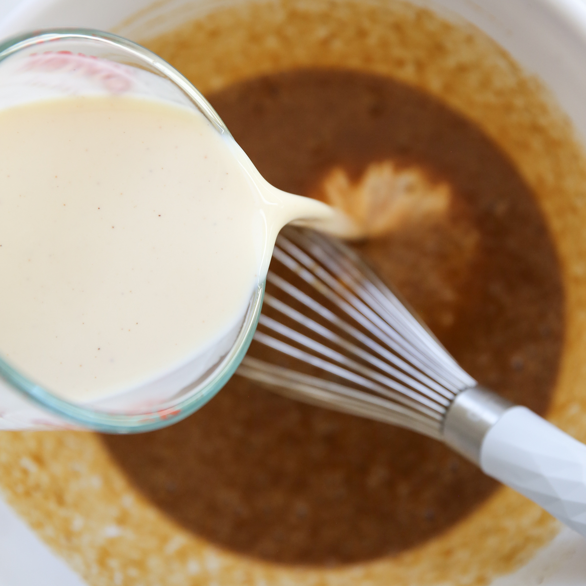 pouring milk into pumpkin custard bowl