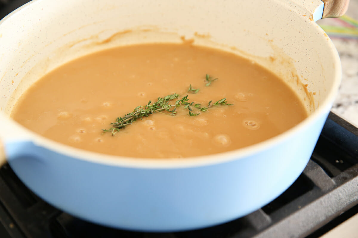 simmering herbs in gravy