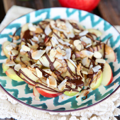 Chocolate-Peanut Butter Apples with Almonds & Coconut on a plate