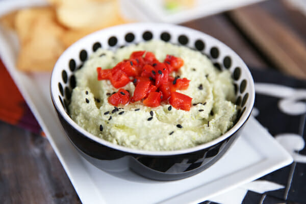 Edamame hummus topped with red peppers