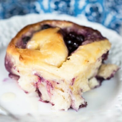 A lemon blueberry roll on a white plate.