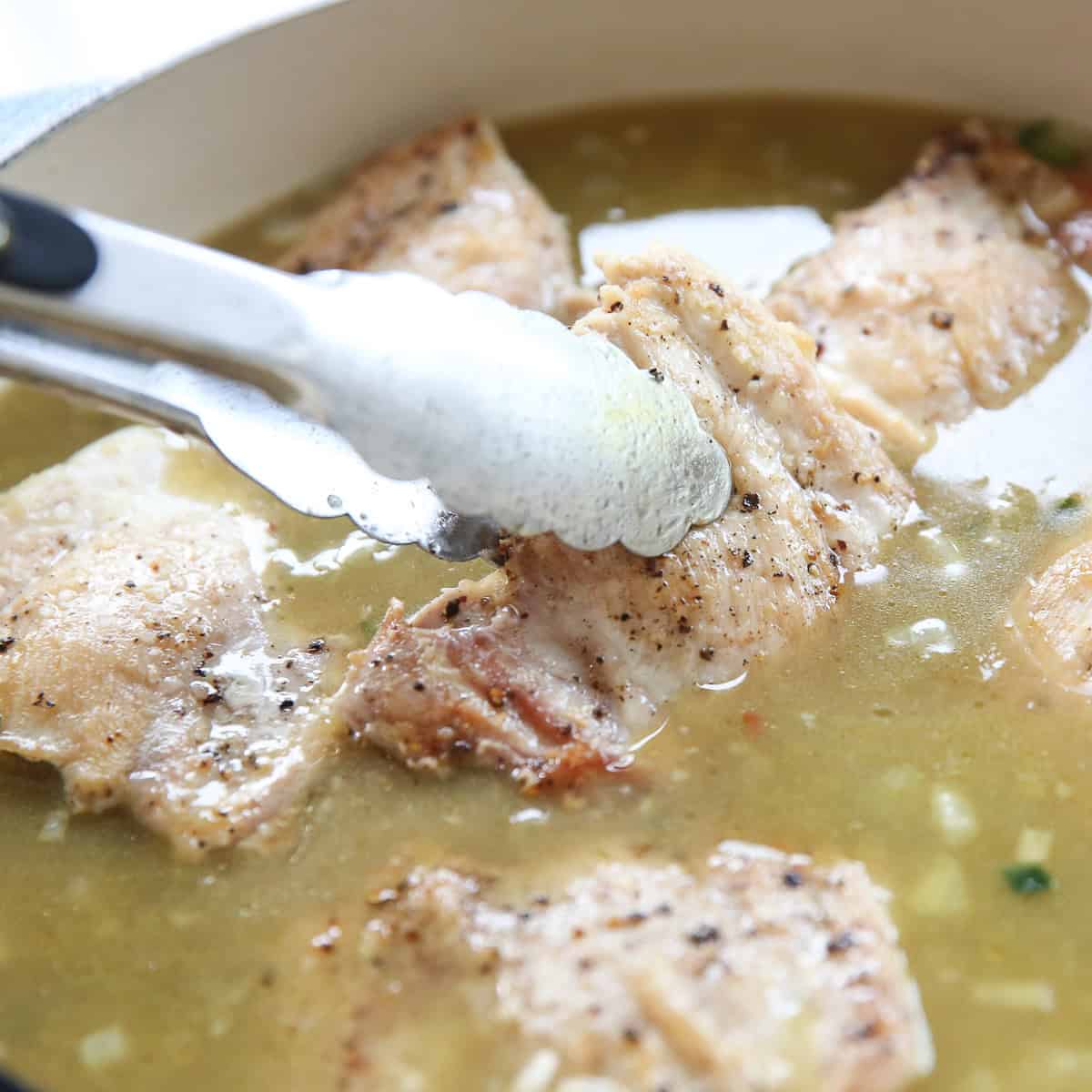 placing chicken back into skillet with rice and liquids