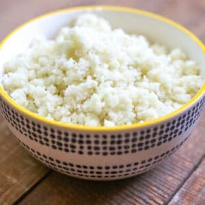 A bowl of cauliflower rice on a table.