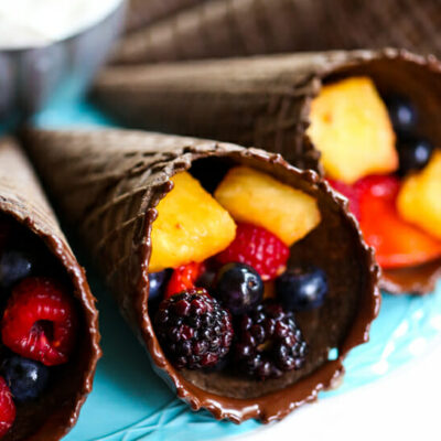 Chocolate ice cream cones, dipped in chocolate and filled with mixed fruit.