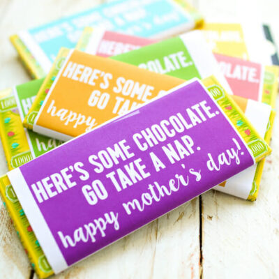 Candy bar printables on a pile of candy bars. THe one on top says, "Here's some chocolate. Go take a nap. Happy Mother's Day!"