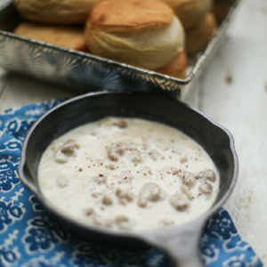 Biscuits in a pan and gravy in a skillet
