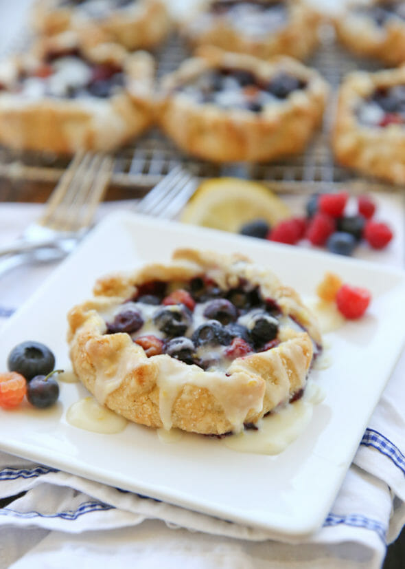 Lemon-Glazed Berry Galettes with Cornmeal Crust - Our Best Bites