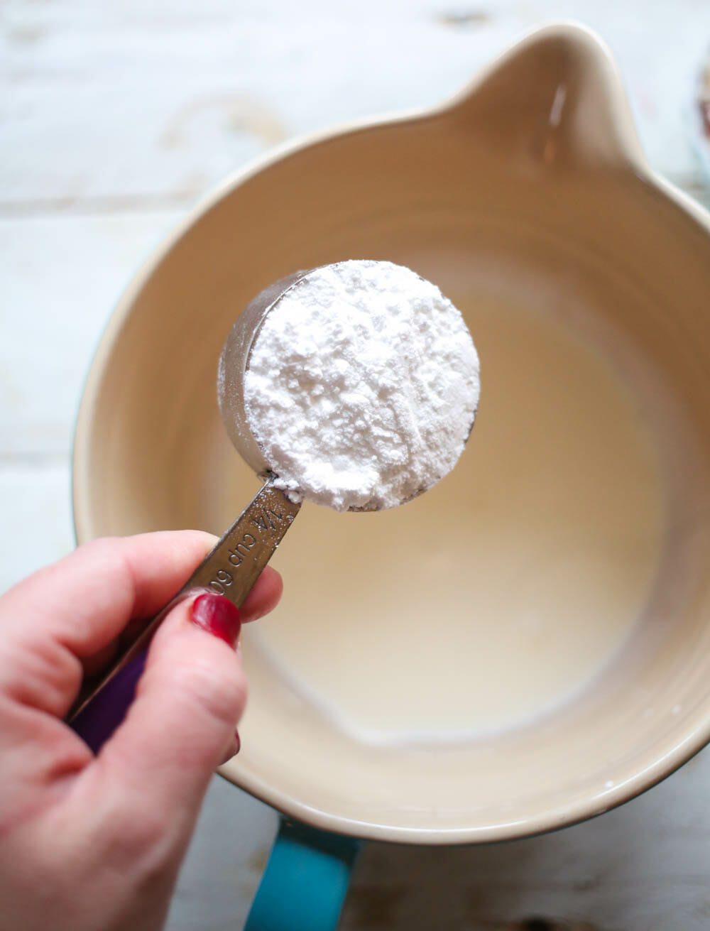 adding powdered sugar to heavy whipping cream