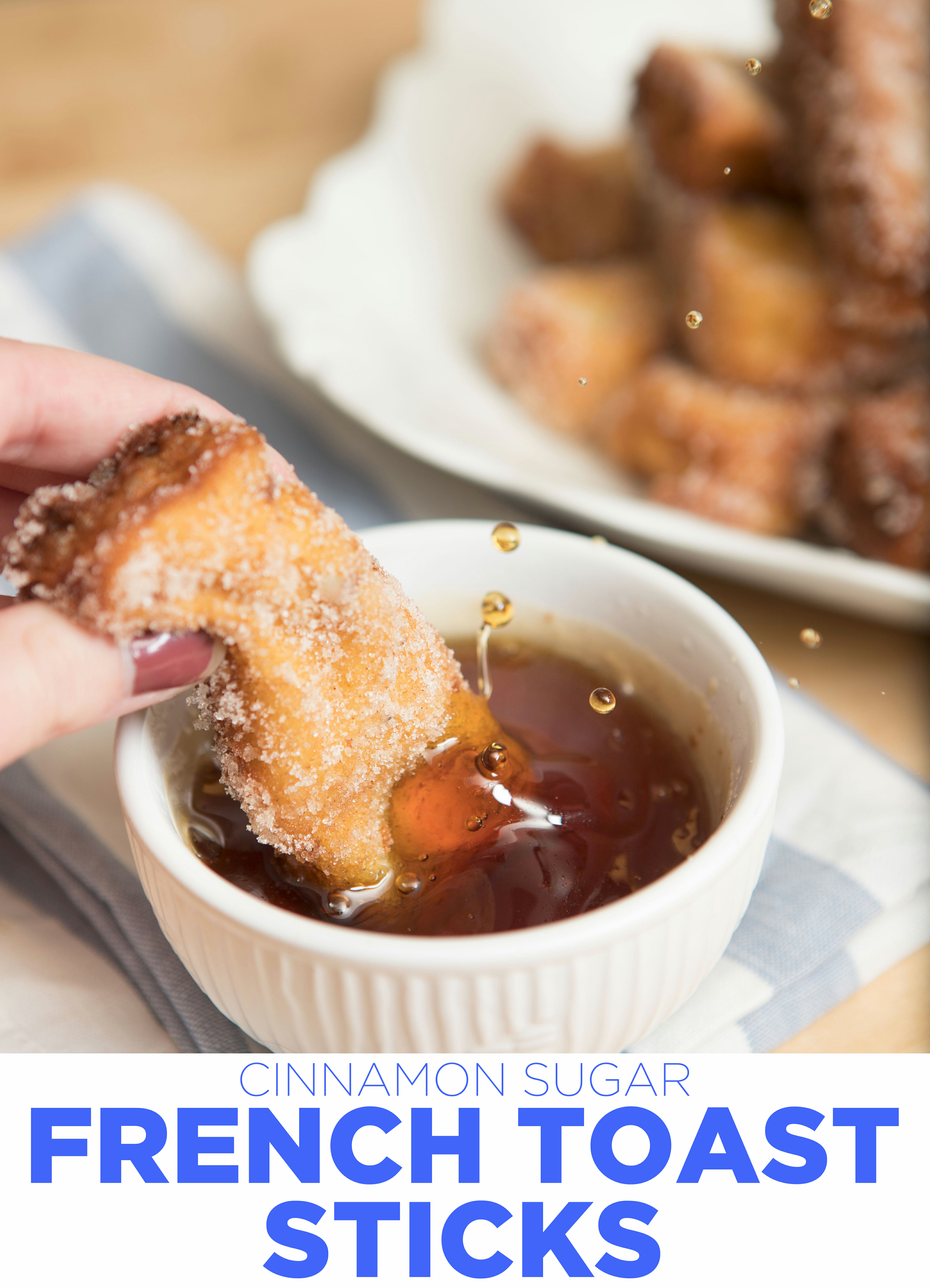 dunking french toast stick in syrup